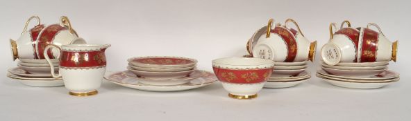 An Edwardian style Gladstone red, white and gilt painted leaf pattern tea service.