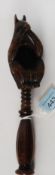 A Black Forest carved oak nutcracker in the form of a squirrel having twist handle with nut recess
