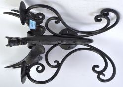 An unusual cast metal / iron wall sconce in the form of an oriental dragon