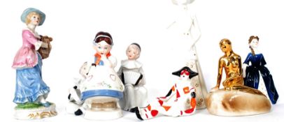A collection of 8x assorted ceramic figurines to include Royal Doulton, Poole, clowns,