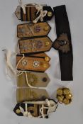 A collection of military shoulder taps and epaulets to include army and navy officers together with