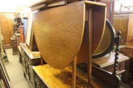 A vintage retro 1970's teak wood drop leaf dining table.