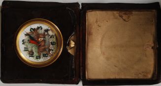 A vintage swiss made leather cased travel clock having hunting scene and subsiduary seconds dial