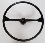 A vintage classic car steering wheel, no makers name.