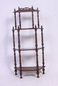 A Victorian mahogany whatnot corner shelf, each tier supported by turned supports,