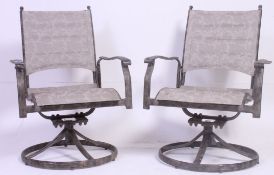 A pair of 20th century  contemporary Industrial style tubular framed swivel garden chairs raised on