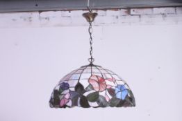 A large  glass panel Tiffany style glass lamp shade with floral design. 50 degrees.