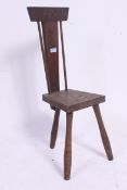 An Arts & Crafts spinning chair with carved legs, stamped for Bensetter Of Totnes rustic stool,