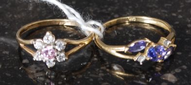 2 9ct gold ladies dress rings to include flower head ring and blue sapphire garnet stone set ring.