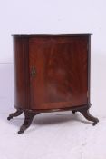 An excellent quality regency style mahogany and leather side drum cabinet.