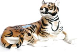 A ceramic figurine of a recumbant Siberian tiger being stamped to the underside USSR.