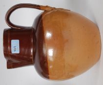 A very large 19th century stoneware ewer - jug with scrolled handled having fleur de lys strap to