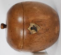 A fruitwood tea caddy in the form of an apple having hinged top with key escutcheon to front