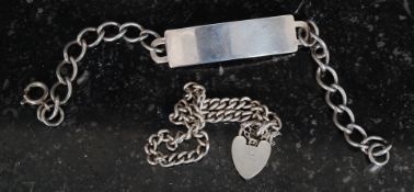 A hallmarked silver unengraved identity bracelet along with a hallmarked silver charm bracelet.