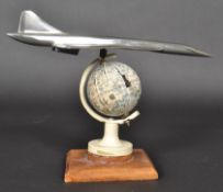 An apprentice piece Concorde set over globe and wooden plinth made by vendors family member who
