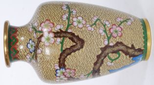 A 20th century cloisonne vase on brass depicting floral scenes