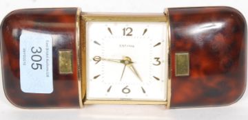 ESTYMA; a vintage simulated tortoiseshell cased self winding travelling clock,