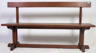 A good solid oak 20th century pig bench having planked seat and back rests with legs united by