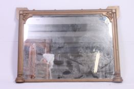 A vintage Gilt overmantel wall mirror having column sided frame with central mirror plate.