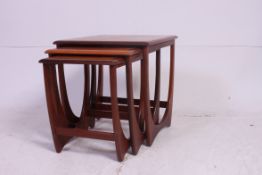 A retro 1970's G-Plan Nest of table in teak raised on angular supports having chamfered edge