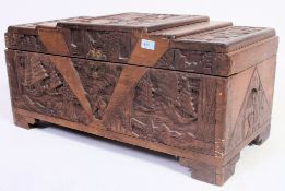 A 20th century Chinese 1950's carved blanket box chest having detailed carvings to front and top