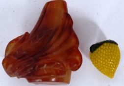 A Chinese agate stone snuff bottle being carved with leaves together with a peking glass yellow and