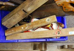 A collection of vintage woodworking tools to include a large oversized wooden plane with another.