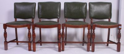 A set of four matching 1940's oak green leatherette panel back dining chairs being raised on cup