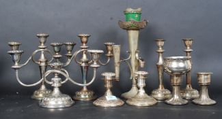 A collection of silver plated candelabras along with a silver plated table epergne.