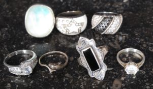 A collection of seven silver metal rings,