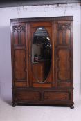 A 1920's Jacobean revival oak single wardrobe.