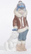 A Lladro figurine ' Eskimo Boy with Pet ' Bearing impressed model  No 5238 with blue stamp to base.