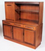 A 1970's G-Plan teak wood Fresco sideboard having a series of cupboards and drawers flanking an