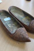 A pair of unusual early 20th century hand carved wooden decorative shoes - each having a careful