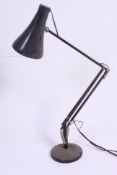 A post war black Herbert Terry Industrial office anglepoise desk lamp raised on circular base with