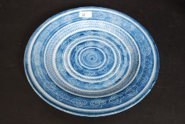 A large continental delft blue and white plate dating to the 20th century being marked to verso