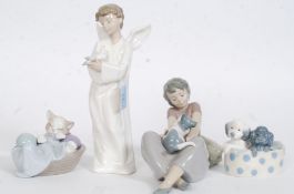 A collection of 4 Nao by Lladro figurines to include Boy With Angel No 1261,