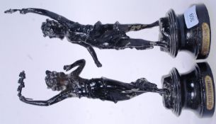 A pair of ebonised cast metal female figurines mounted on socle bases with applied plaques for Le