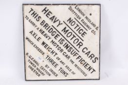 A large and impressive reproduction LMS Railways wall sign warning of a bridge ahead.