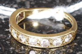 An 18ct gold and diamond half eternity ring having inset 8 channel set diamonds approx 45pnts each.