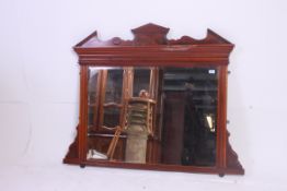 A large Edwardian walnut overmantel mirror having decorative show wood frame with cornice top