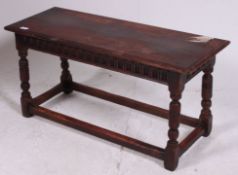 An early 20th century Jacobean revival peg jointed ipswitch oak foot stool.