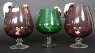 Three over sized studio glass brandy glasses, all complete with ceramic cats and mice.