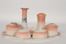 A good early 20th century continental ceramic dressing table set in pink with floral sprays