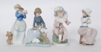 A collection of Nao figurines to include pierrot boy with dog, girl with rabbits on log,