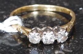 A vintage 18ct gold 3 stone diamond ring. Each diamond bezel mounted approx .10pnts each.