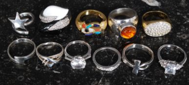 A collection of silver, gilded silver and white metal ladies dress rings.