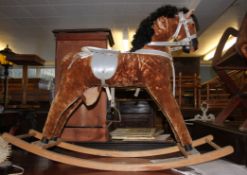 A vintage 20th century rocking horse raised on wooden sleigh runners with upholstered horse atop