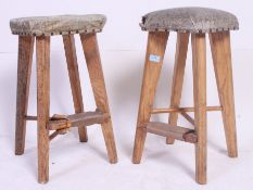 A near pair of vintage retro stools having studded seat pads, tapered legs.