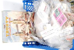 A collection of vintage stamps some within an album along with several packs sorted into countries